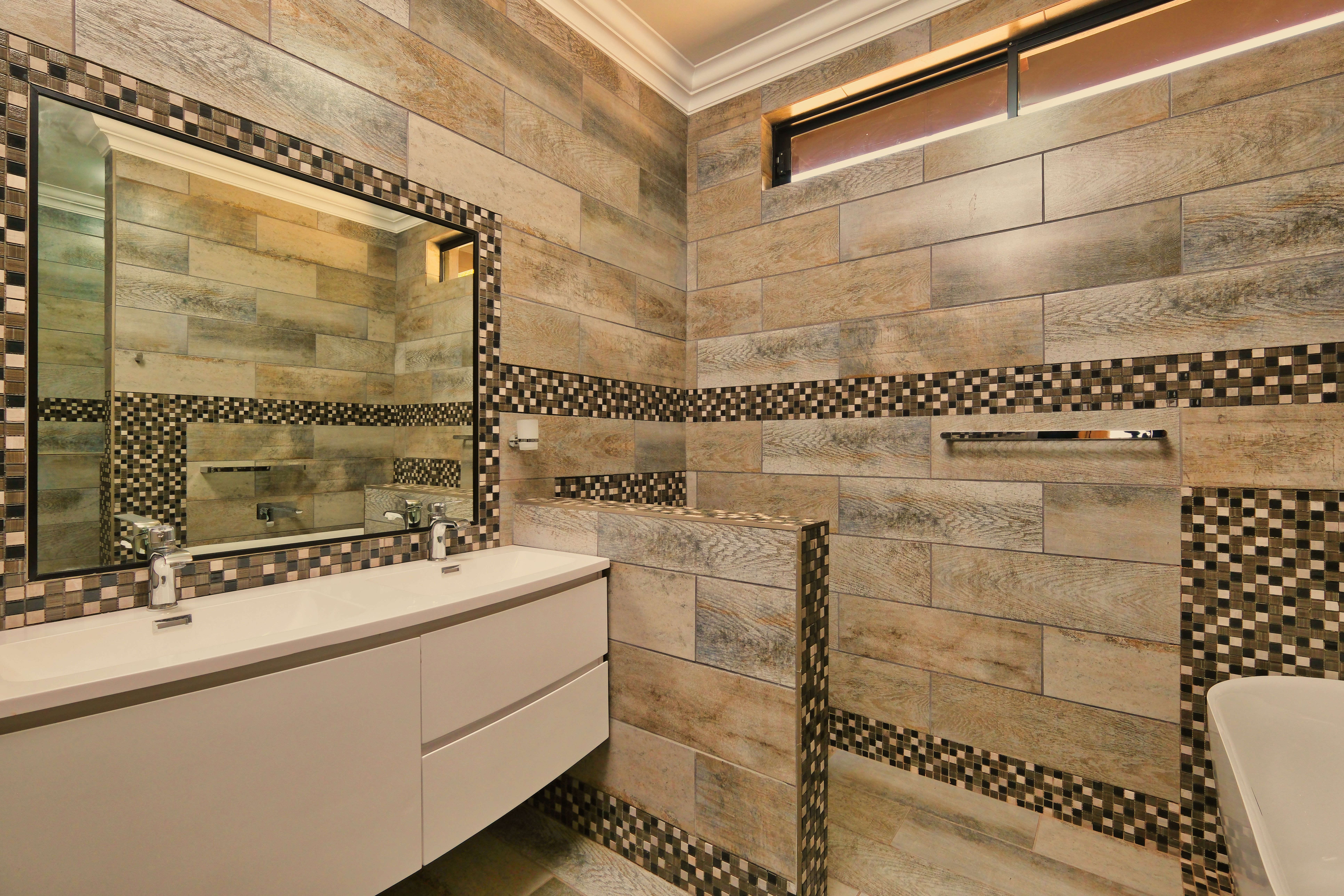 Fully refitted modern bathroom with large format tiles and walk-in shower